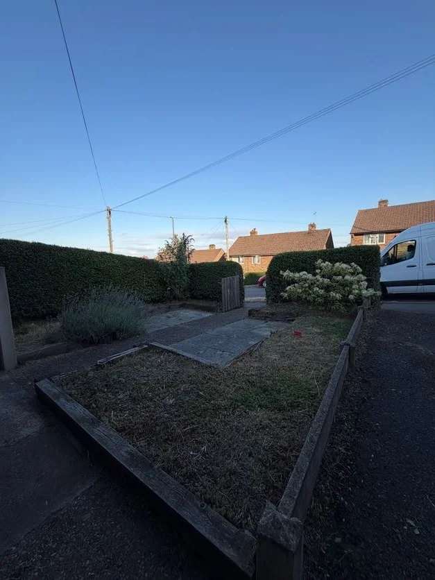 Garden in Derby after a tidy-up: cleared borders and neat lawn